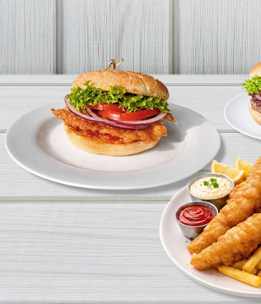 Fish burger and a plate of fish and chips with lemon and tartare
