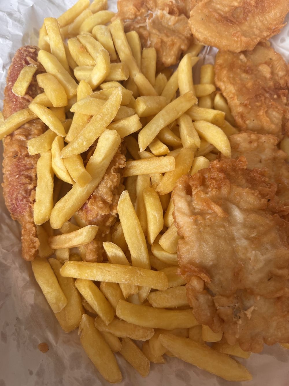 Battered fish on a bed of golden chips, fresh from the fryer
